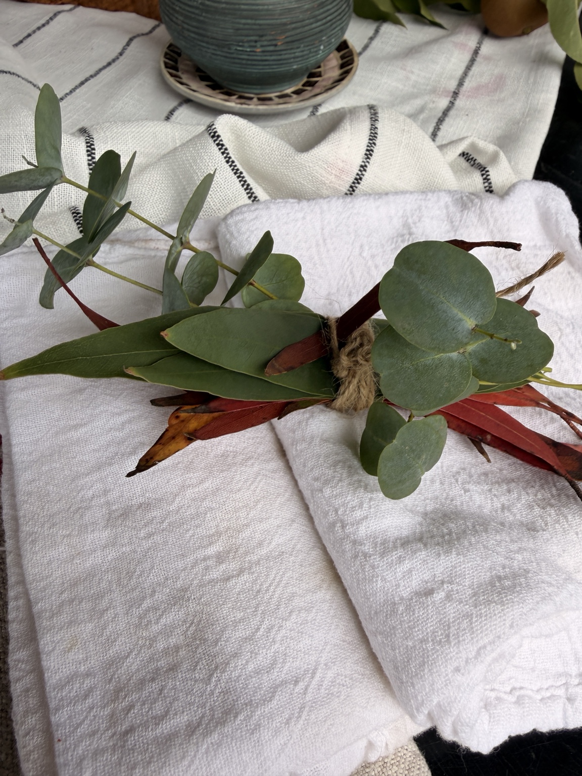 Hand-tied dried eucalyptus bouquet with blue-green and russet leaves